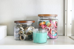 Simple & Stylish Craft Studio Organization. Use large glass jars or containers to organize small odds and ends.