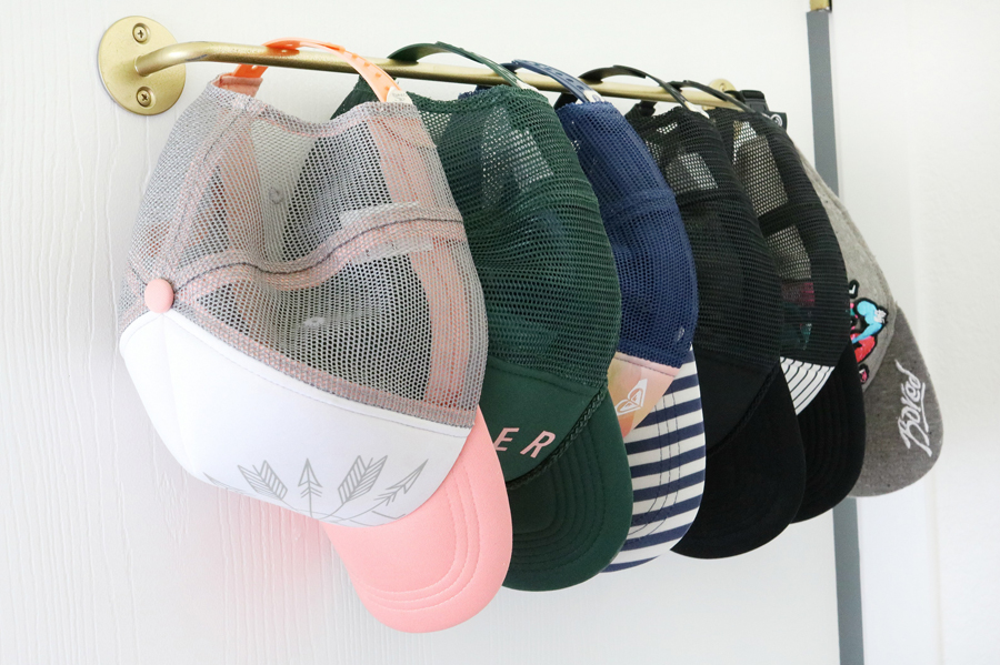 Hang hats on metal bar for easy organization in small spaces The Crafted Sparrow