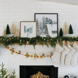 Add Live Garland to Your Neutral Decor and Modern Winter Prints for a Cozy Holiday Mantel